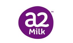 The image features the logo for A2 Milk. It consists of the text "a2 Milk™" in white, with the "a2" in a larger, stylized font, and the word "Milk" in a smaller, standard font beneath it. The text is within a purple, irregularly-shaped circle.
